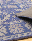 Rustic Oriental Blue Hand Tufted Wool Rug, showcasing its intricate, hand-tufted construction, blends deep blues and earthy tones in a distressed oriental pattern, lending a timeless, rustic charm to the room.