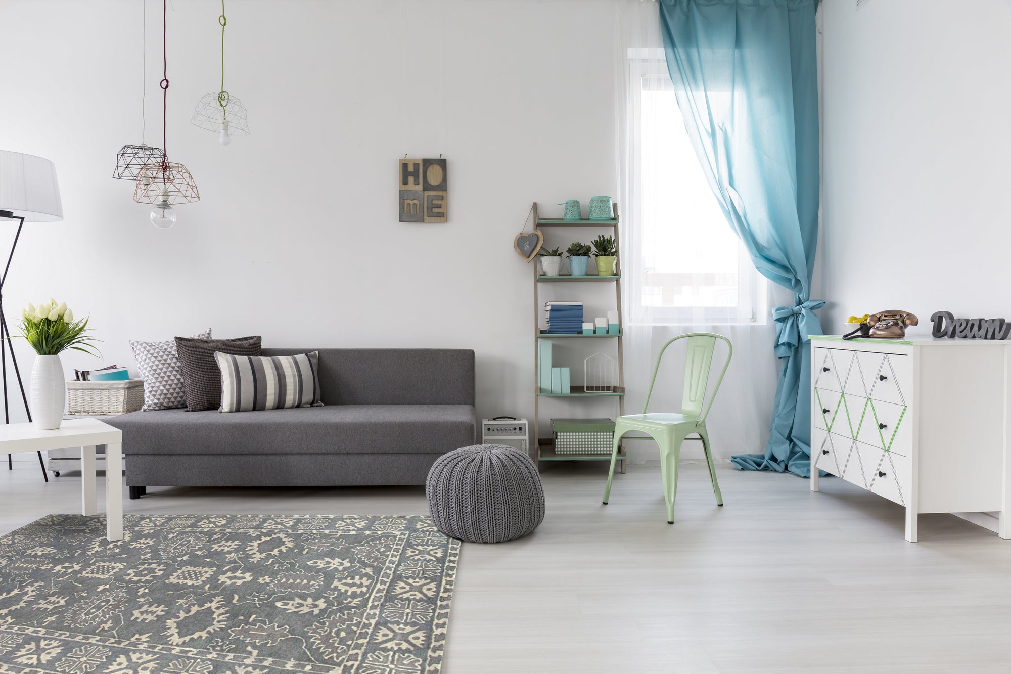 Louie Oriental Gray Hand Tufted Wool Rug, its intricate gray patterns softly grounded in a modern living room setting.