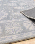 Louie Oriental Gray Hand Tufted Wool Rug gracing a well-lit living room. Soft gray wool pile showcases intricate oriental patterns. Comfortable and stylish centerpiece.