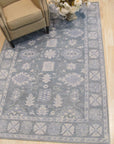 Louie Oriental Gray Hand Tufted Wool Rug, a soft gray wool rug with a classic Oriental pattern, lending warmth and traditional elegance to a room setting.