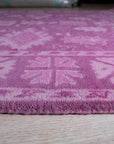 Opulent Oriental Pink Hand Tufted Wool Rug, showcasing a detailed floral pattern in shades of pink and cream, seen in a bright, neutral room setting.