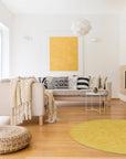 Comfortable Oriental Yellow Hand Tufted Wool Rug, showcasing intricate floral motifs in warm yellow hues, hand-tufted for plush texture and enduring comfort, positioned in a bright, naturally lit living room.