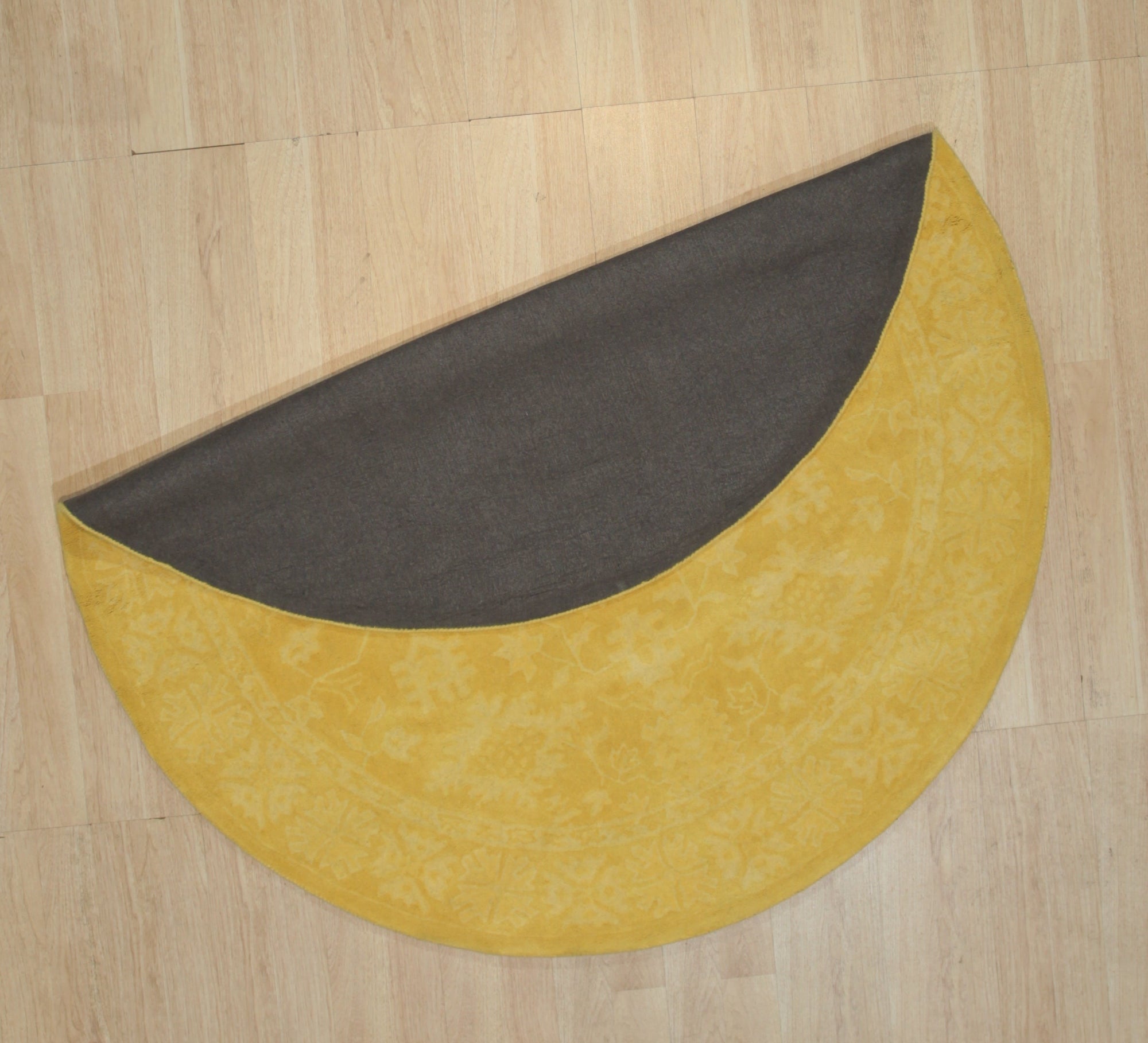 Comfortable Oriental Yellow Hand Tufted Wool Rug, showcasing a vibrant, hand-tufted wool rug with intricate oriental patterns in shades of yellow, gold, and muted browns, adding warmth and texture to a brightly lit room.
