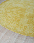 Comfortable Oriental Yellow Hand Tufted Wool Rug, a vibrant splash of sunshine yellow anchored by intricate floral motifs, hand-tufted for a luxurious, textured feel underfoot, displayed within a warmly lit living space.