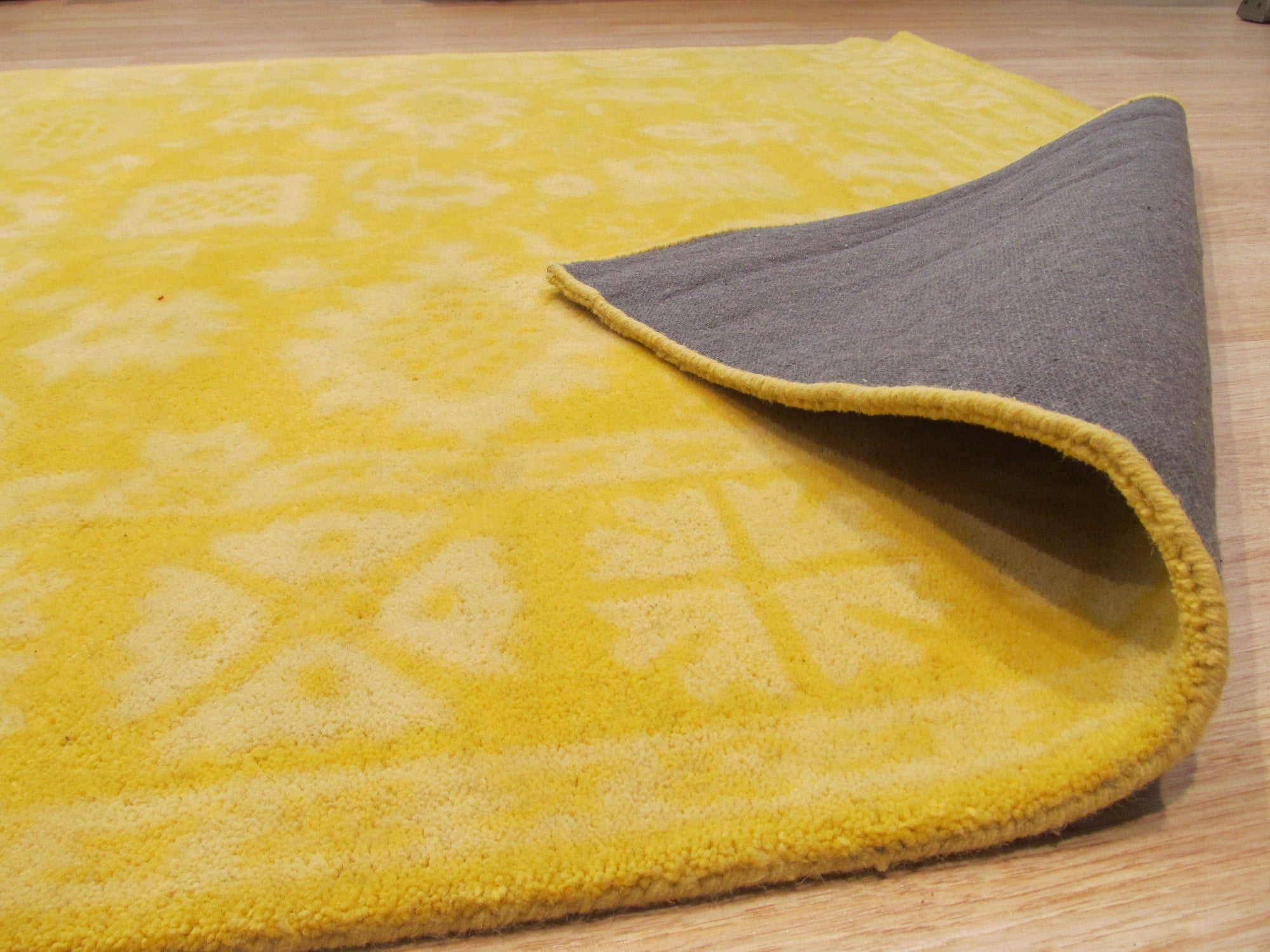 Comfortable Oriental Yellow Hand Tufted Wool Rug, vibrant yellows and intricate patterns grace this hand-tufted wool rug, creating a warm and inviting space.