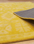 Comfortable Oriental Yellow Hand Tufted Wool Rug, vibrant yellows and intricate patterns grace this hand-tufted wool rug, creating a warm and inviting space.