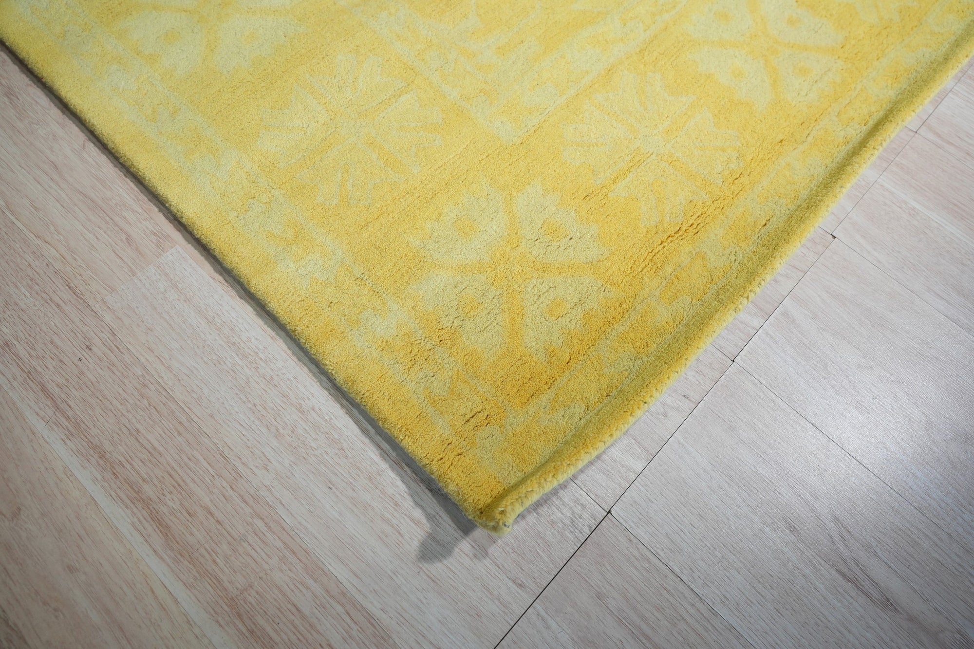 Comfortable Oriental Yellow Hand Tufted Wool Rug, a vibrant yellow wool rug with an intricate oriental design, displayed in a bright, airy living room setting.