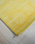 Comfortable Oriental Yellow Hand Tufted Wool Rug, a vibrant yellow wool rug with an intricate oriental design, displayed in a bright, airy living room setting.