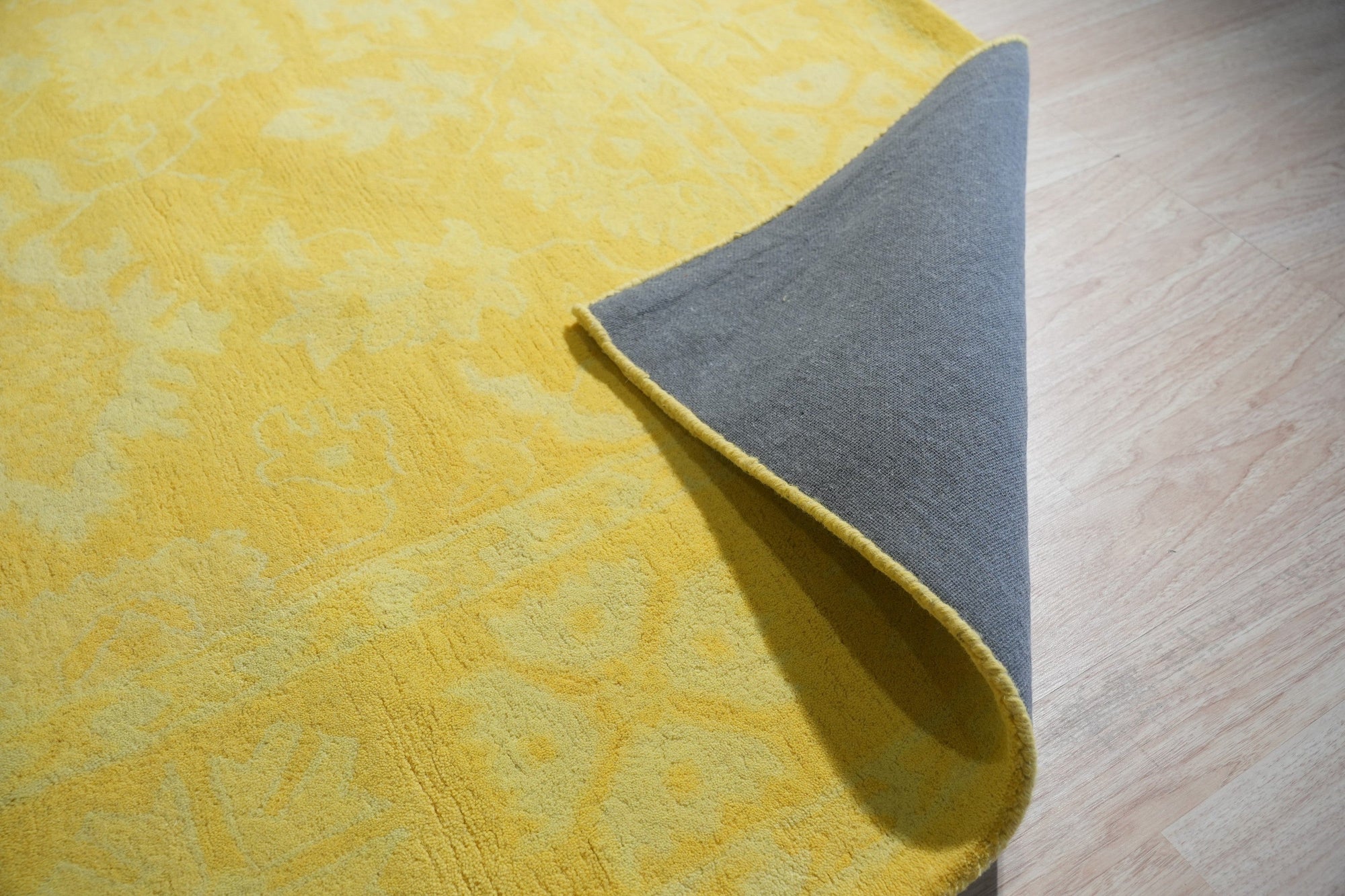 Comfortable Oriental Yellow Hand Tufted Wool Rug, vibrant yellows and intricate floral patterns bloom across a hand-tufted wool rug, softly illuminating a bright, modern living space.