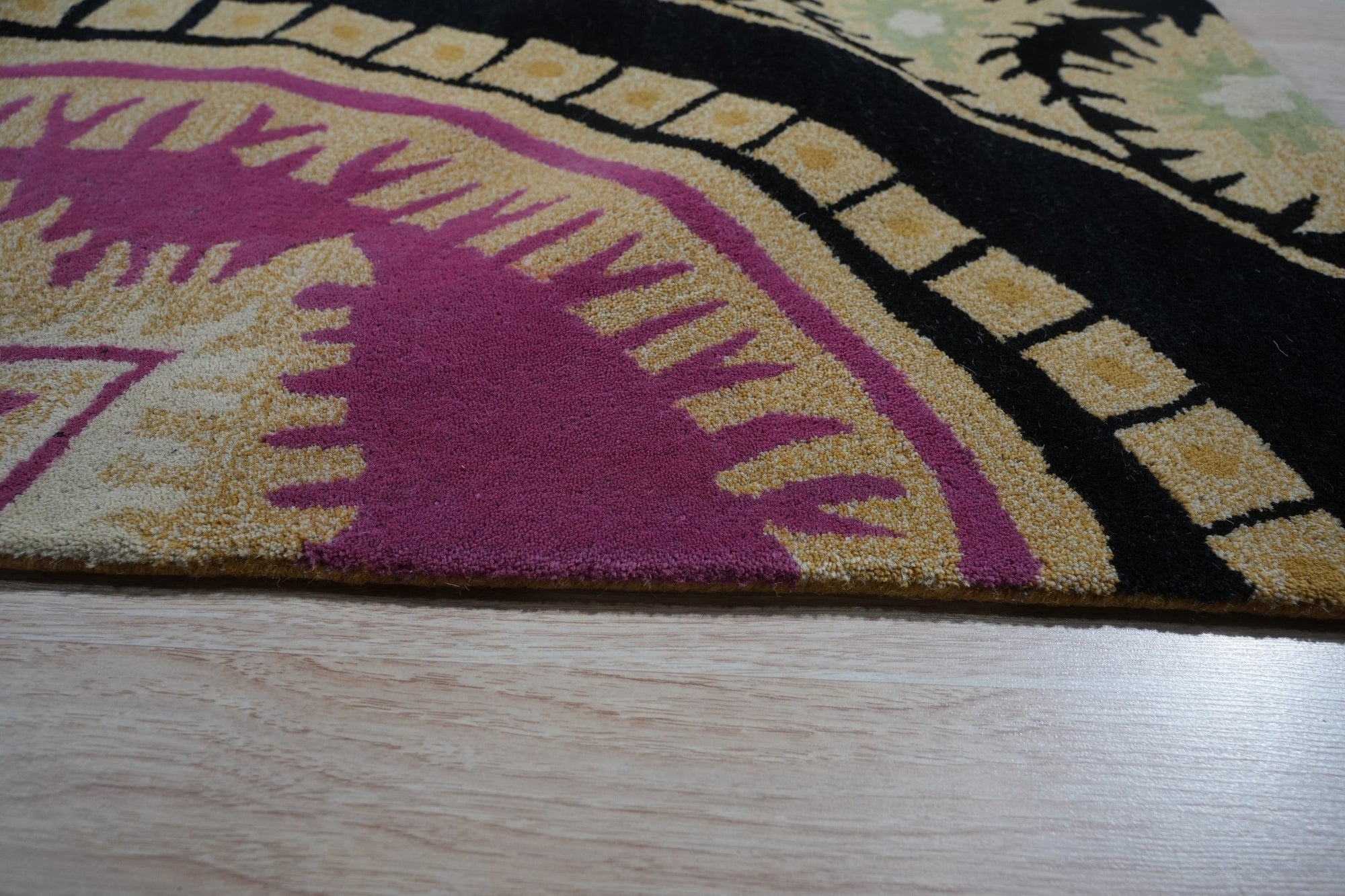 Opulent Nina Black Hand Tufted Wool Rug, showcasing its intricate, possibly geometric, design in a living room setting, likely placed under furniture and providing warmth to the space.