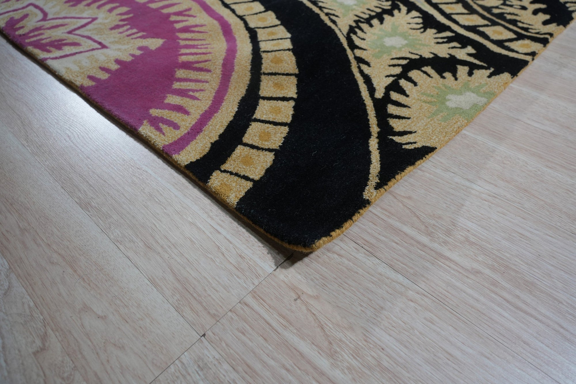 Opulent Nina Black Hand Tufted Wool Rug, showcasing a swirling, high-pile design in deep black, filling the frame with luxurious texture.