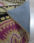 Opulent Nina Black Hand Tufted Wool Rug, showcasing its intricate geometric pattern of cream on black, creating a modern yet luxurious feel within a bright, airy living space.