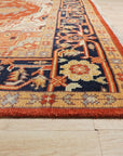 Harlow Oriental Rust Hand Knotted Wool Rug displayed in a bright living room setting; a warm, intricately patterned wool rug anchors the space with rich rust hues and traditional oriental motifs.
