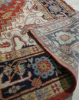 Exquisite Traditional Red Hand Knotted Wool Rug, its intricate floral patterns and deep reds adding warmth to a softly lit interior.