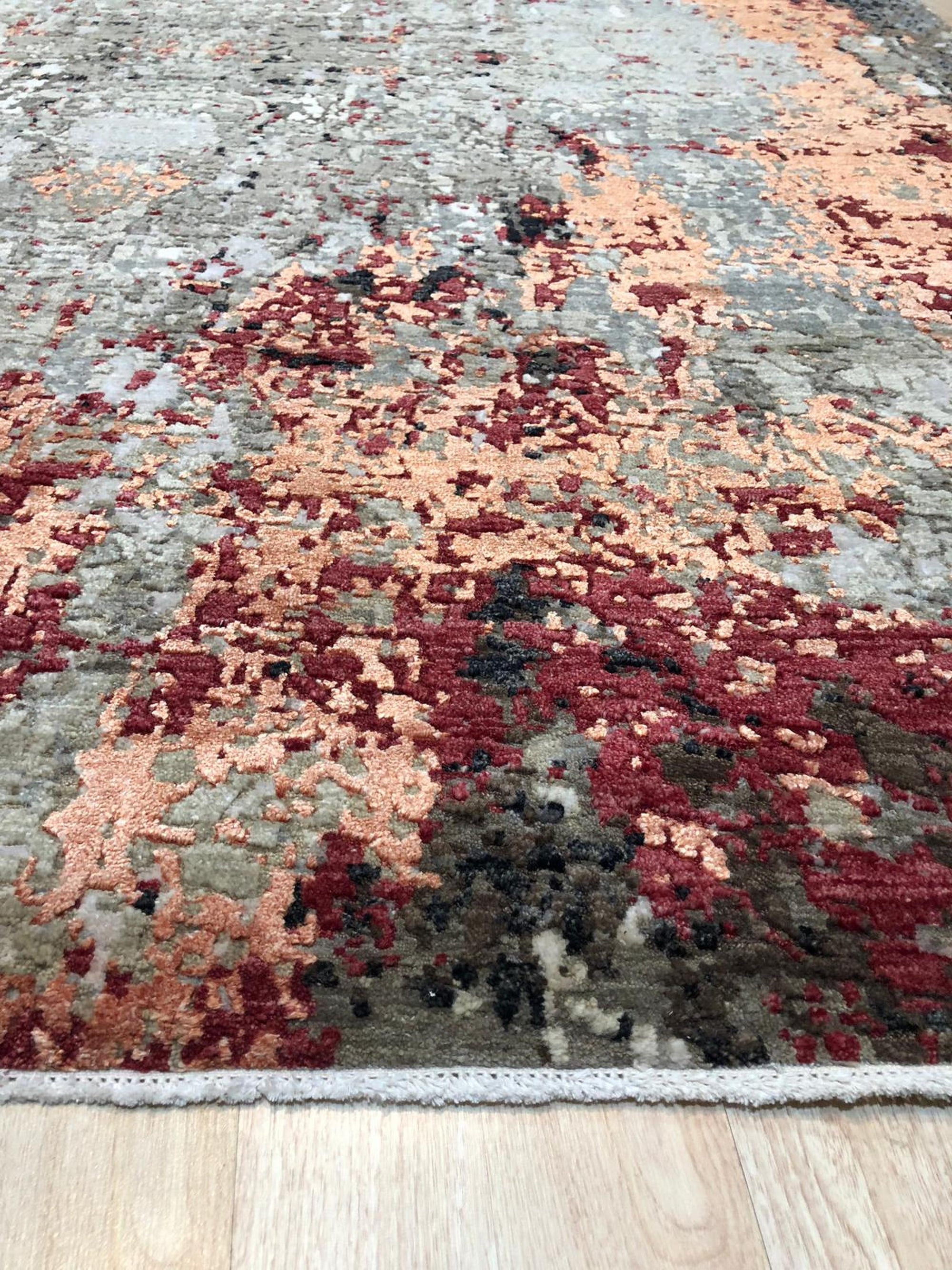 Isla Sumptuous Gray Hand Knotted Wool Rug, a plush gray wool rug with subtle variations in pile height and texture, creating a luxurious and inviting floor covering in a well-lit space.