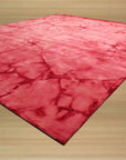 Sarrah Giselle Pink Hand Knotted Wool Rug, showcasing a detailed floral pattern in shades of pink, cream, and gray, creating a soft and luxurious feel in a bright, modern living space.