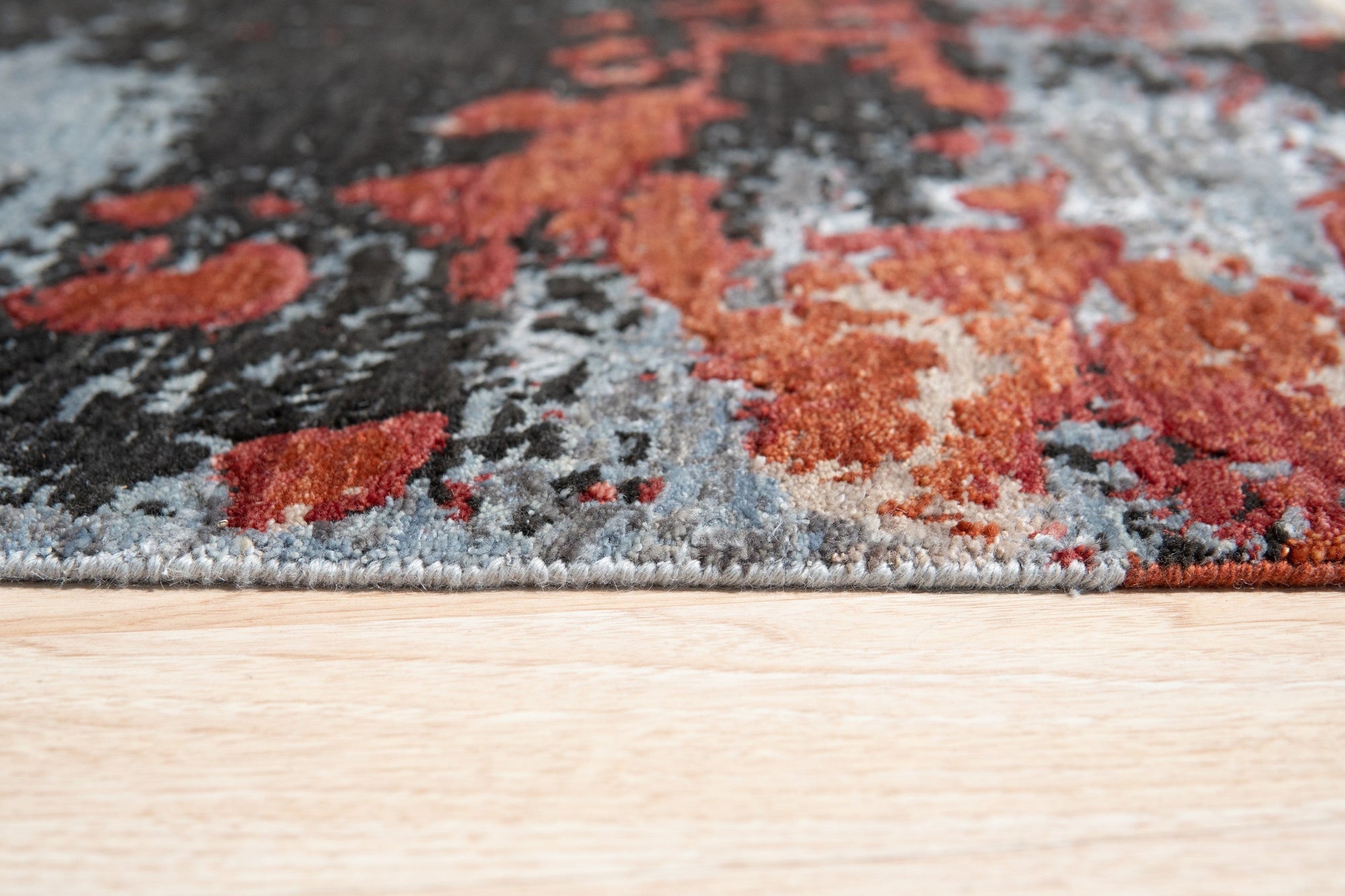 Kira Sophie Gray Hand Knotted Wool Rug, a textural blend of soft grays in a hand-knotted wool construction, subtly elevates a light-filled living space.