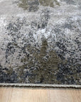 Xena Chloe Gray Hand Knotted Wool Rug, textured gray wool floor covering with subtle pattern variations and fringed edges, softening a light-filled living space.