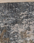 Xena Chloe Gray Hand Knotted Wool Rug, showcasing intricate knotwork and a soft, gray palette, displayed in a bright, airy living room setting.