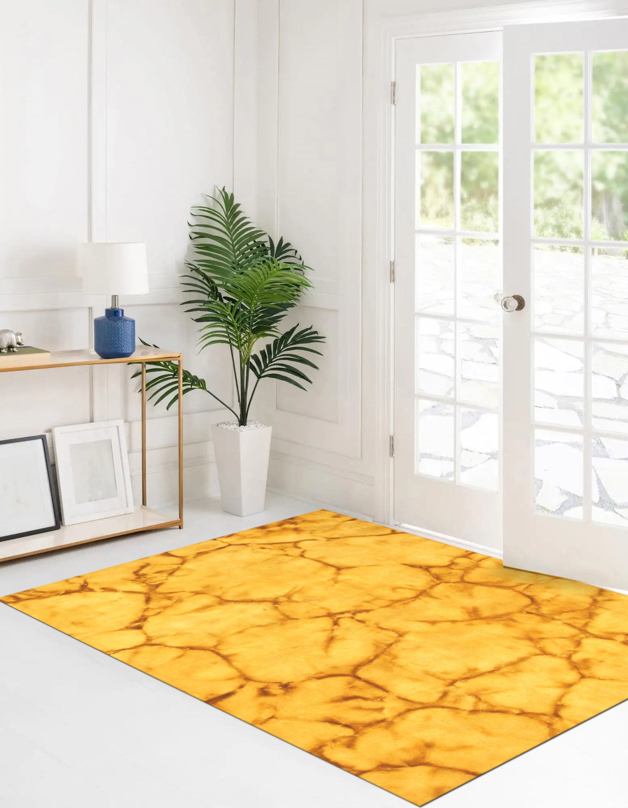 Yara Sarrah Gold Hand Knotted Wool Rug displayed on a light hardwood floor, its golden hues and intricate hand-knotted design adding warmth and texture to the space.