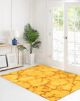 Yara Sarrah Gold Hand Knotted Wool Rug displayed on a light hardwood floor, its golden hues and intricate hand-knotted design adding warmth and texture to the space.
