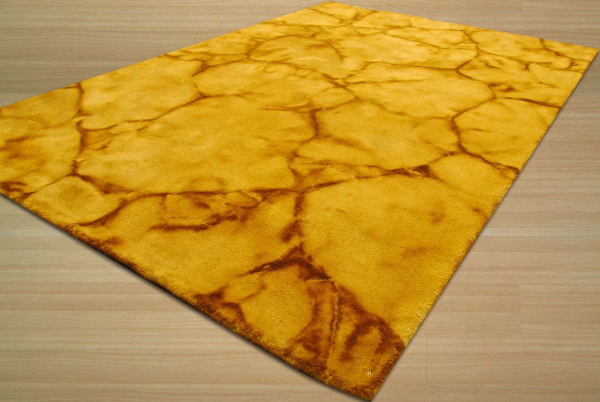Yara Sarrah Gold Hand Knotted Wool Rug displayed, its subtle gold tones and intricate hand-knotted construction complementing a modern living space with neutral furniture and natural light.