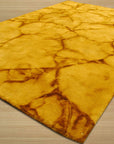 Yara Sarrah Gold Hand Knotted Wool Rug displayed, its subtle gold tones and intricate hand-knotted construction complementing a modern living space with neutral furniture and natural light.