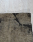 Luxurious Warm Brown Hand Knotted Wool Rug, a deeply saturated brown hand-knotted wool rug with subtle tonal variations, filling a warmly lit living space.