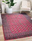 Rustic Nina Red Nan Rug, showcases a complex geometric pattern in vibrant red, cream, and charcoal hues, lending warmth and texture to a modern living room.