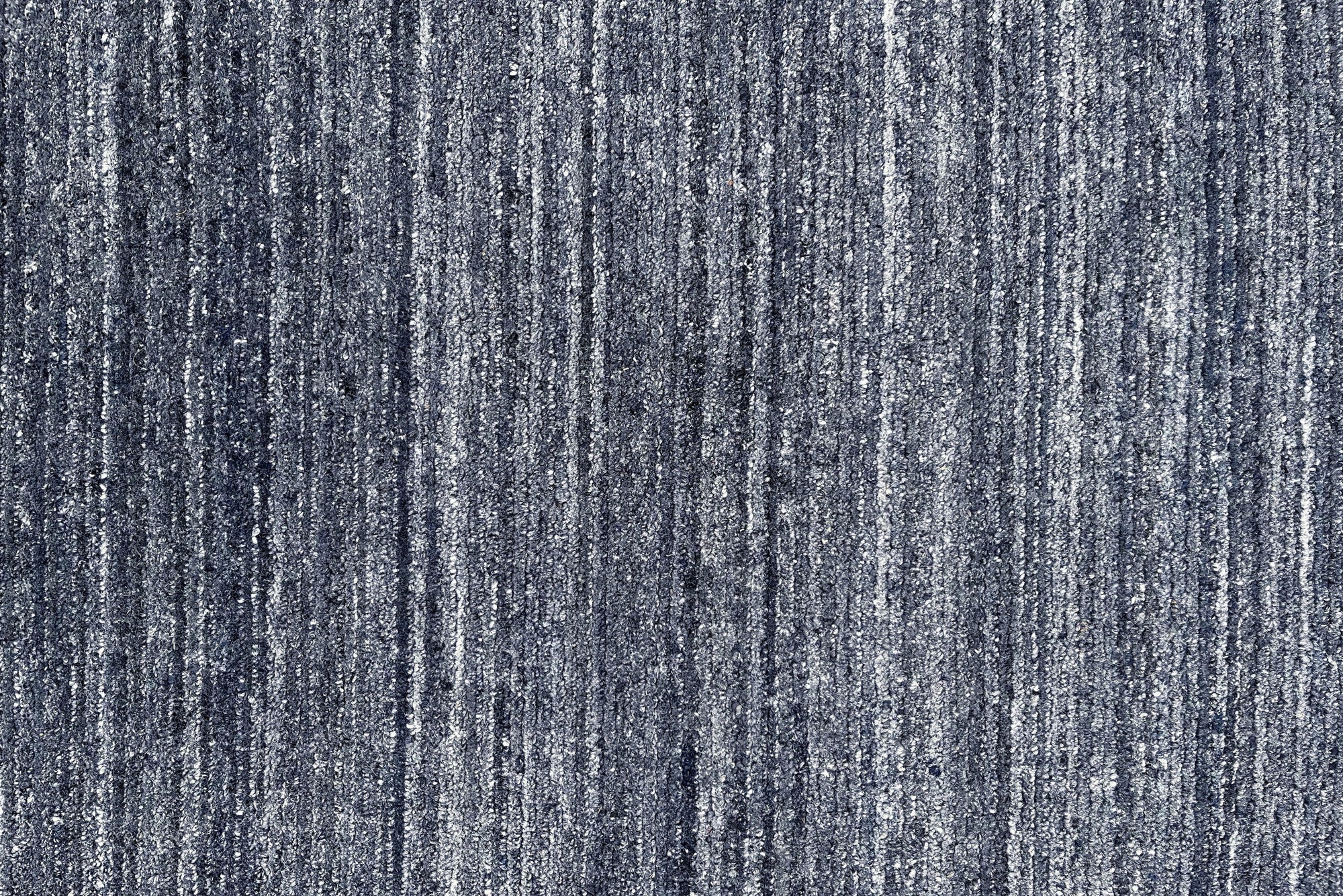 Delicate Striped Charcoal Handmade Wool Rug, features charcoal stripes woven into handmade wool, creating a textured and modern floor covering in a living room setting with neutral furniture.