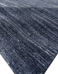 Delicate Striped Charcoal Handmade Wool Rug, its subtle charcoal stripes creating a sophisticated pattern across the soft, handwoven wool, laid against a neutral backdrop.