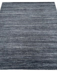 Delicate Striped Charcoal Handmade Wool Rug, its charcoal stripes create a subtle gradient across the hand-knotted wool surface, adding depth and texture to a room setting.