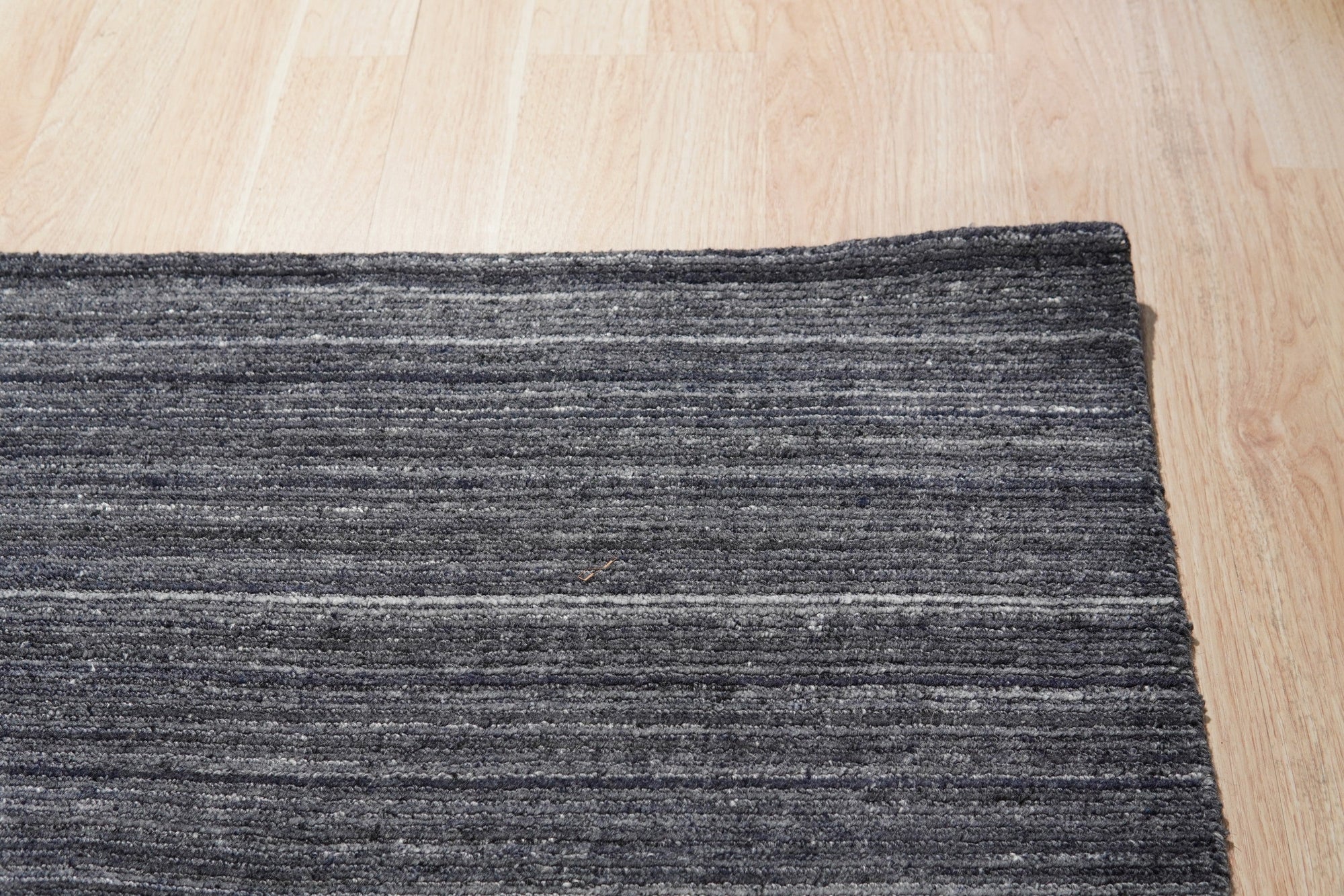 Delicate Striped Charcoal Handmade Wool Rug, soft charcoal and creamy white stripes alternating across hand-loomed wool, lends subtle sophistication to a modern living space.