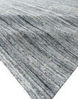 Delicate Striped Gray Handmade Wool Rug, displaying subtle gray stripes in a warm, inviting living space.
