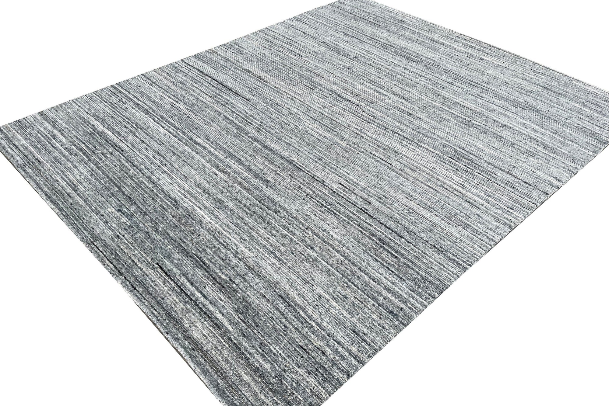 Delicate Striped Gray Handmade Wool Rug, showcasing soft gray and cream stripes in a tightly woven wool construction, seen in a bright, modern room setting.
