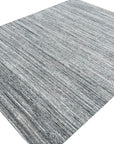 Delicate Striped Gray Handmade Wool Rug, showcasing soft gray and cream stripes in a tightly woven wool construction, seen in a bright, modern room setting.
