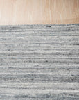 Delicate Striped Gray Handmade Wool Rug in a bright living space, showing a subtle striped pattern and soft texture underfoot.