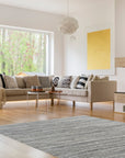 Delicate Striped Ivory Handmade Wool Rug, showcasing subtle ivory stripes in a living room setting, blending seamlessly with neutral furniture for a calming, textured floor covering.