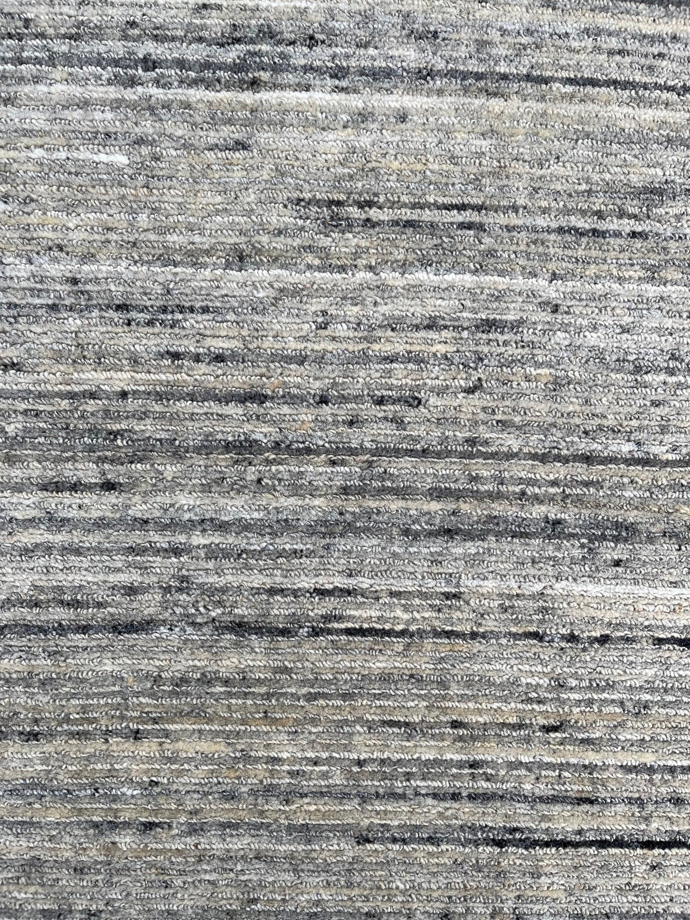 Delicate Striped Ivory Handmade Wool Rug, showcasing soft ivory hues and subtle stripes in a warm, inviting living space.