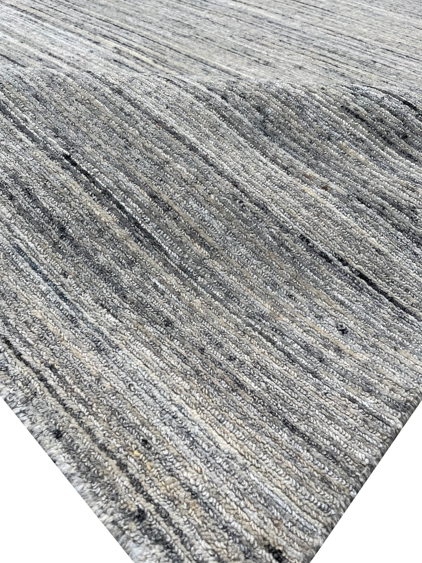 Delicate Striped Ivory Handmade Wool Rug, its soft ivory stripes adding subtle texture to any floor, showcasing its handmade wool construction and striped pattern in a bright, modern setting.