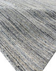 Delicate Striped Ivory Handmade Wool Rug, its soft ivory stripes adding subtle texture to any floor, showcasing its handmade wool construction and striped pattern in a bright, modern setting.