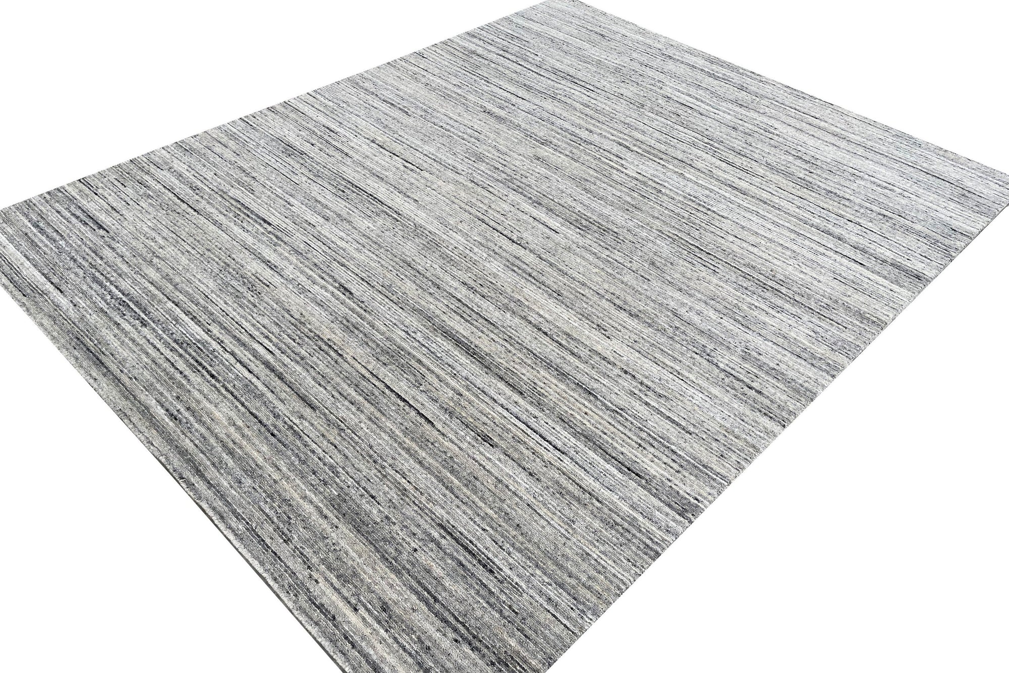 Delicate Striped Ivory Handmade Wool Rug, showcasing its soft ivory tones and subtle striped pattern across a room setting with natural light flooding in, highlighting the handcrafted wool texture.