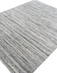 Delicate Striped Ivory Handmade Wool Rug, showcasing its soft ivory tones and subtle striped pattern across a room setting with natural light flooding in, highlighting the handcrafted wool texture.