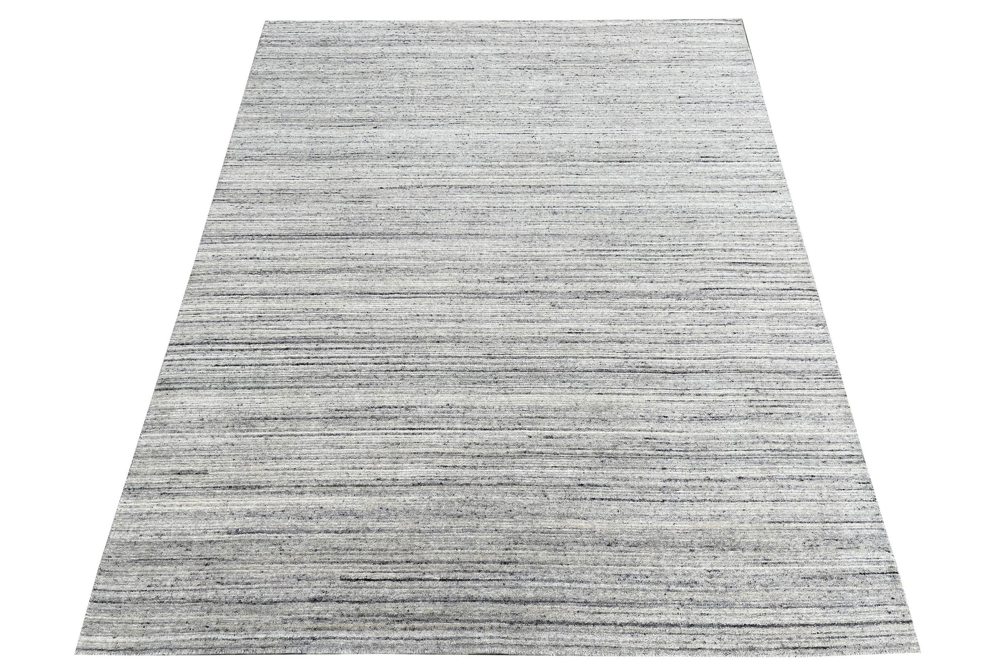 Delicate Striped Silver Handmade Wool Rug, showcasing subtle silver stripes on a textured wool surface, adding understated elegance to a well-lit interior space.