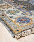 Lila Ruby Charcoal Hand Knotted Wool Rug, deep charcoal tones interwoven with ruby accents, its hand-knotted wool construction evident in the detailed texture, complements a modern living space.