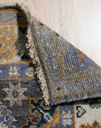 Lila Ruby Charcoal Hand Knotted Wool Rug anchors a softly lit living space. Charcoal hues blend with ruby accents in this hand-knotted wool rug, adding warmth and texture to the modern room.