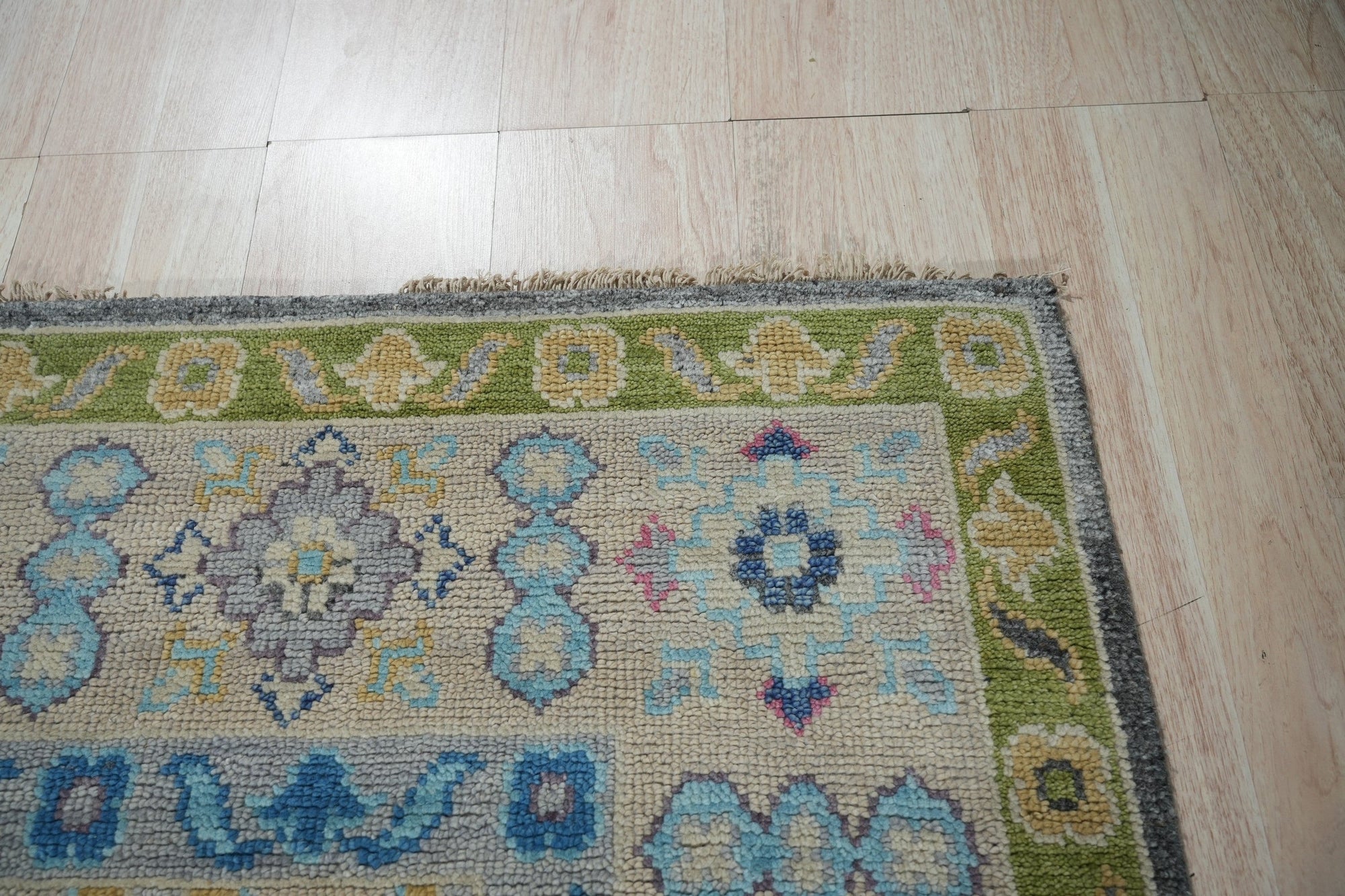 Maya Kazak Charcoal Hand Knotted Wool Rug, blending charcoal hues and traditional Kazak patterns, graces a modern living space with its hand-knotted wool texture and sophisticated warmth.