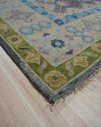 Maya Kazak Charcoal Hand Knotted Wool Rug, its rich charcoal hues and hand-knotted wool construction lending texture and depth to a warmly lit interior space.