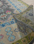 Maya Kazak Charcoal Hand Knotted Wool Rug, a dark charcoal wool rug with traditional Kazak patterns, displayed in a home setting with furniture.