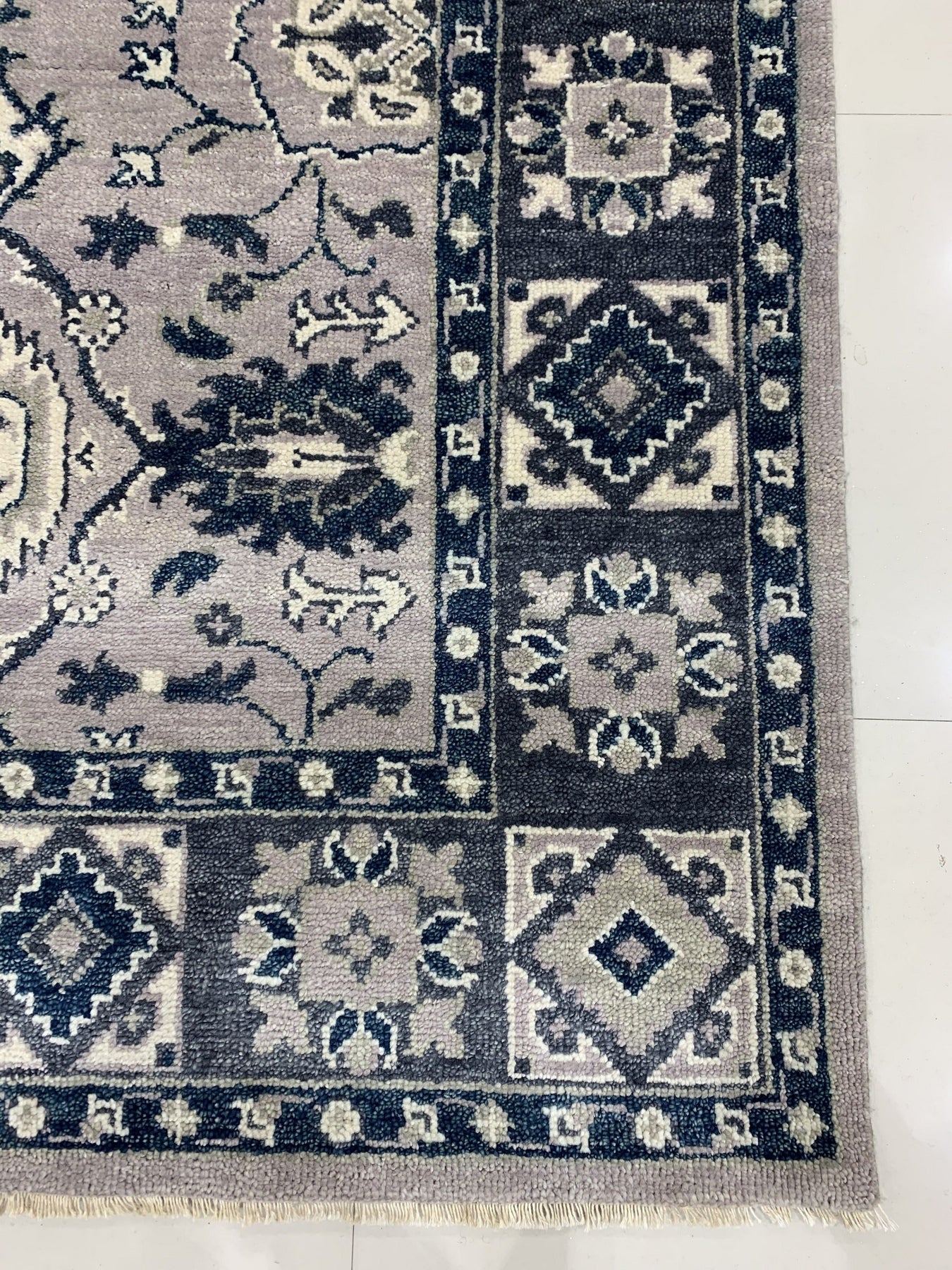 Captivating Jasmine Gray Hand Knotted Wool Rug, a subtle gray wool rug with an intricate hand-knotted floral pattern, softly textures a modern living space.